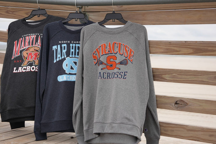 Collegiate Crew Necks hanging on boardwalk railing