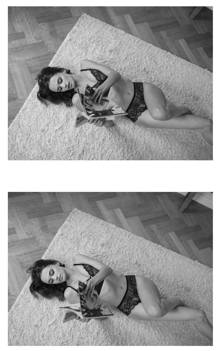 model liggend vogue lezen in zwarte lingerie van pavo couture