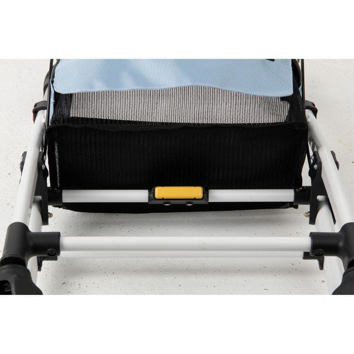 Close-up of the brake mechanism on Breeze Indoor Rollator rollator's wheel with spring and cable detail.