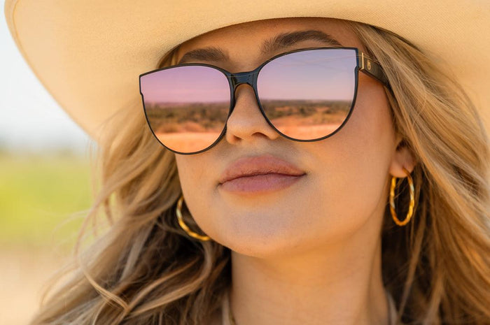 Heat Wave Visual Carat black and rose gold sunglasses worn in a lifestyle setting