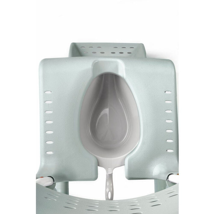 Etac Clean Commode Pan positioned in a home environment such as a bedroom or bathroom, demonstrating its discreet appearance.