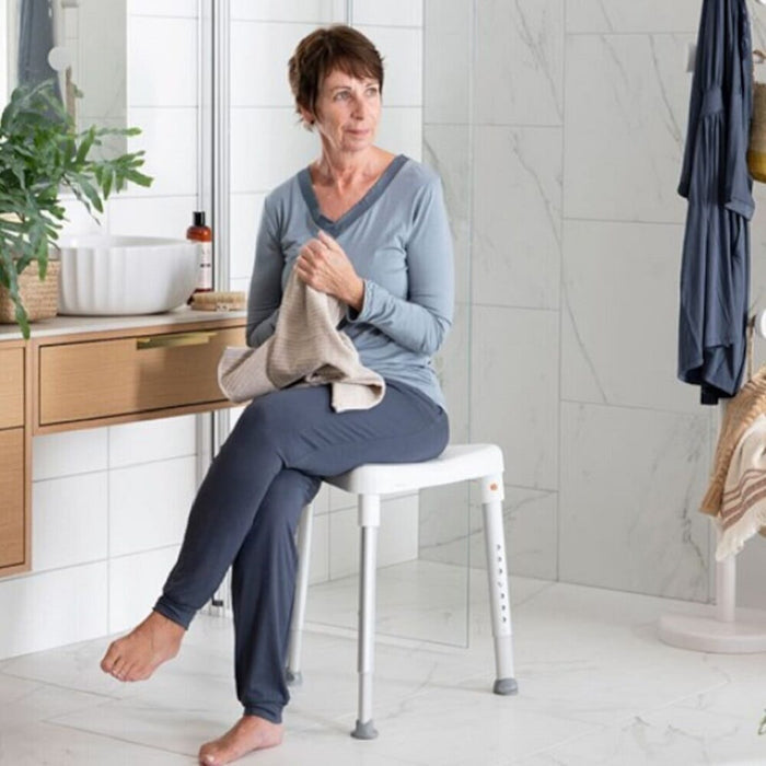 Side view of Etac Edge Shower Stool highlighting the lightweight aluminium legs and non-slip ferrules.