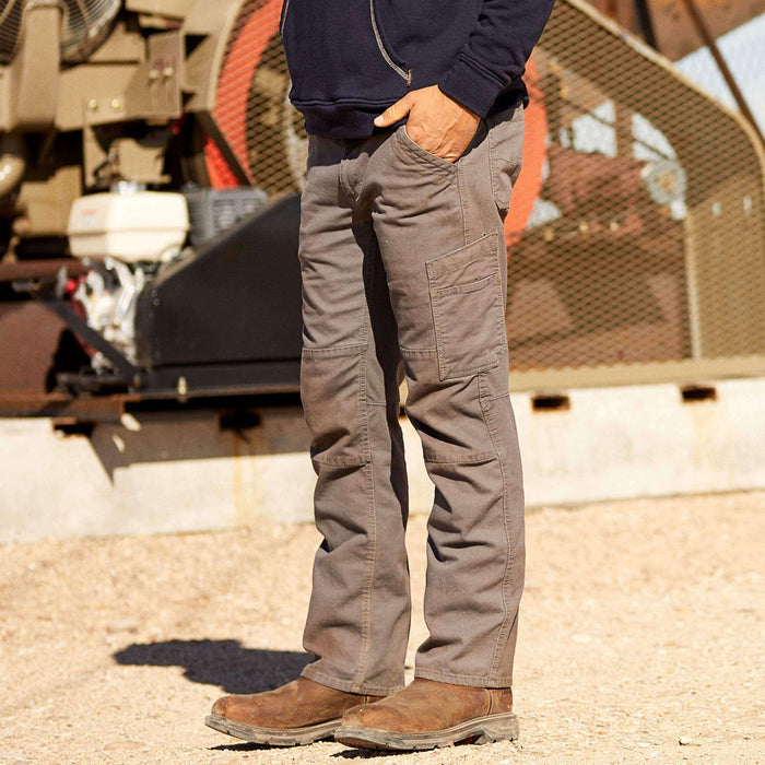 Ariat FR flame resistant canvas work pant in iron gray, shown worn in a job site setting