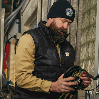 Carhartt Gilliam water resistant vest in black, shown worn in a lifestyle setting