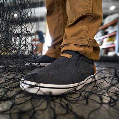 Xtratuf canvas Sharkbyte deck shoe shown worn on a boat deck
