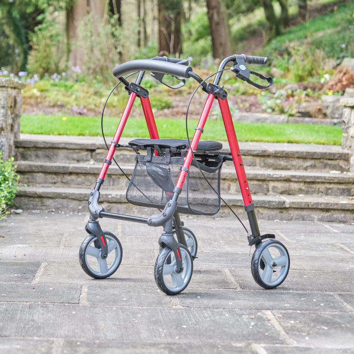 Angled view of NRS 4 Wheel Lightweight Rollator rollator with seat, padded backrest, storage bag and four wheels on a plain background.