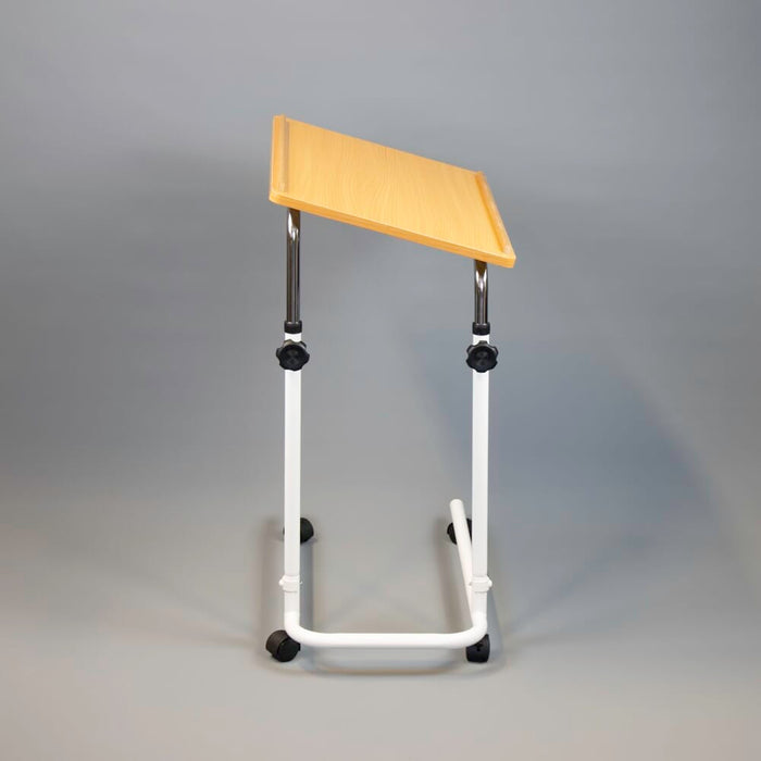 Side view of NRS Beech Overbed Overchair Table showing the tilting top and height-adjustable chrome stems.