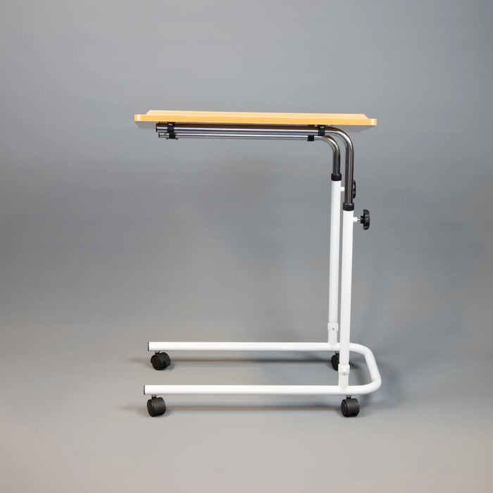 Side view of NRS Beech Overbed Overchair Table with the table top level at its lowest height.