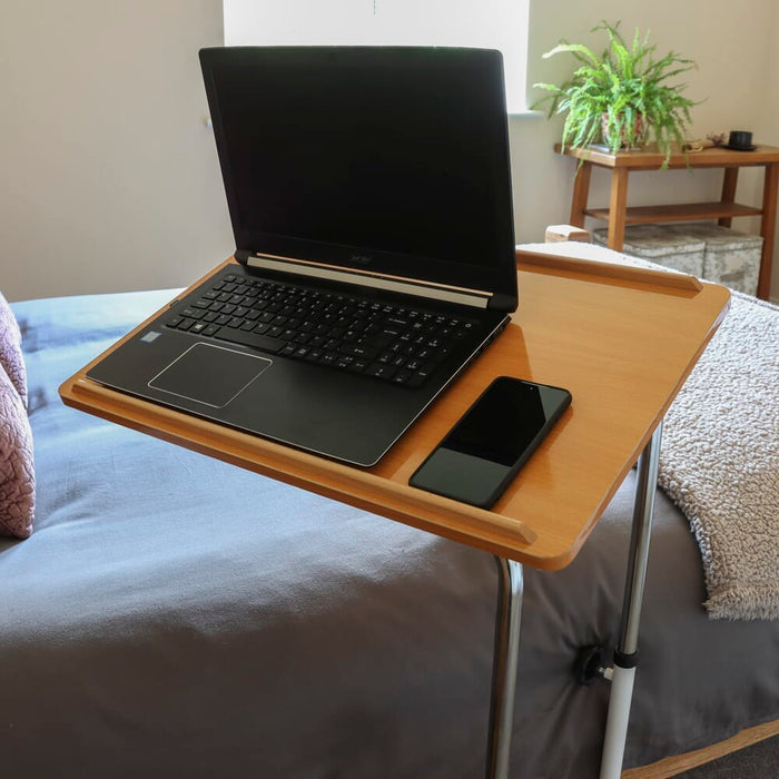 Close-up of the tubular base of NRS Divan Overbed Table, highlighting the sturdy steel frame.