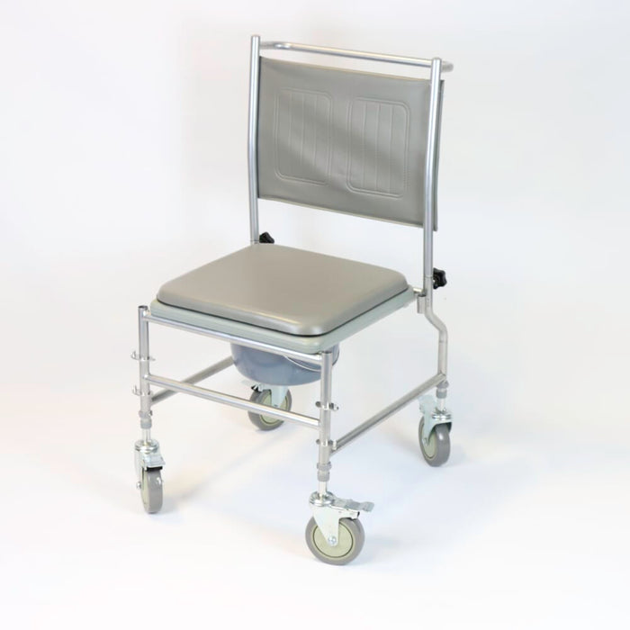 NRS Height Adjustable Wheeled Commode positioned in a home environment such as a bedroom or bathroom, demonstrating its discreet appearance.