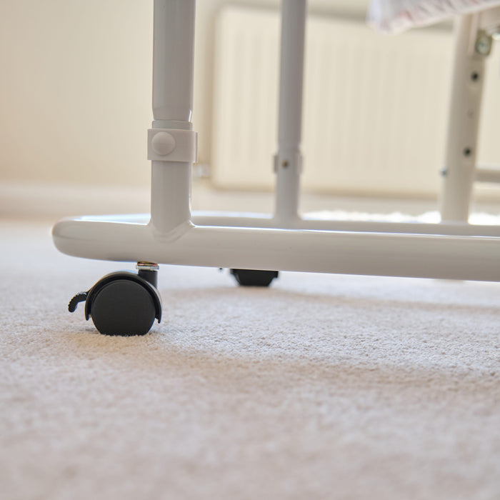 Side view of NRS Overbed Table showing the tilting top and height-adjustable chrome stems.