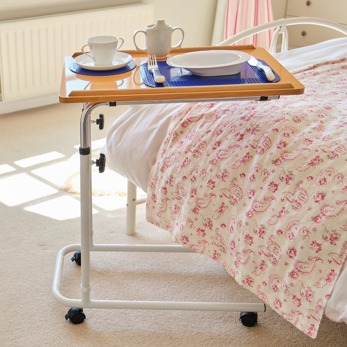 Close-up of a push button or knob on NRS Overbed Table's frame used for adjusting height or tilt.