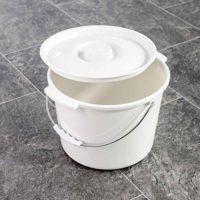 NRS Spare Commode Pan for Height Adjustable Toilet Frame with Seat positioned in a home environment such as a bedroom or bathroom, demonstrating its discreet appearance.