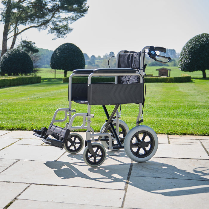 Image of NRS Transit-Lite Attendant Controlled Wheelchair on a plain background.