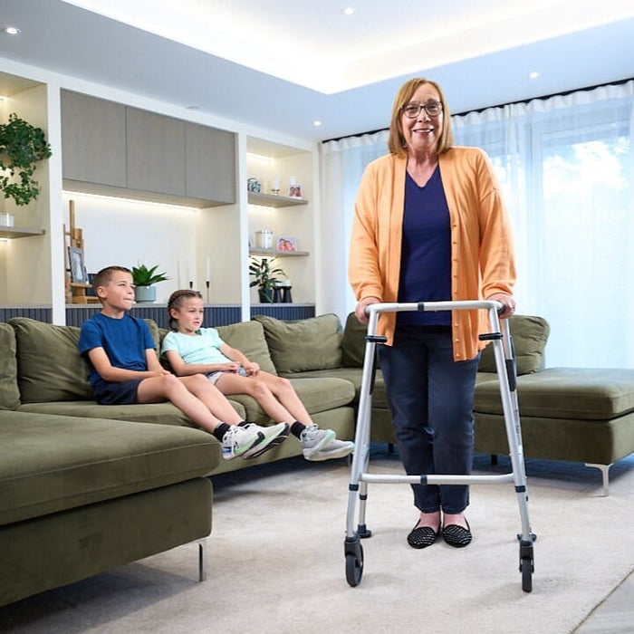 NRS Walk Safe Walking Frame in use: an older adult using the frame at home to move confidently and independently.
