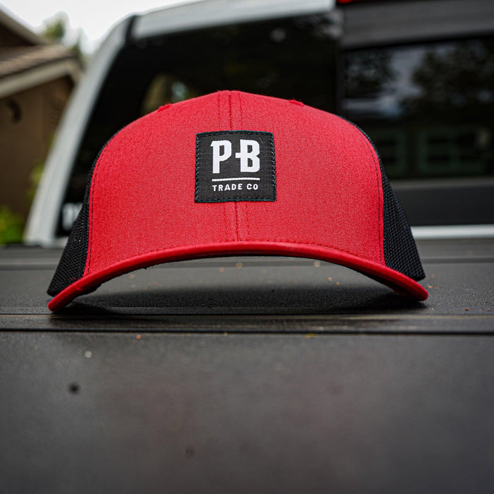 Purpose-Built PB Stadium curved brim hat in red and black worn by a model