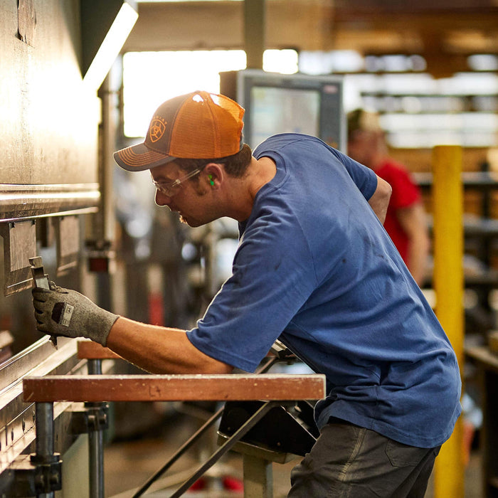 Ariat Rebar Cotton Strong work tee in navy heather, shown worn in a job site setting
