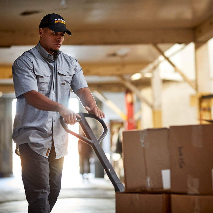 Ariat Rebar VentTEK work shirt in charcoal heather, shown worn in a job site setting