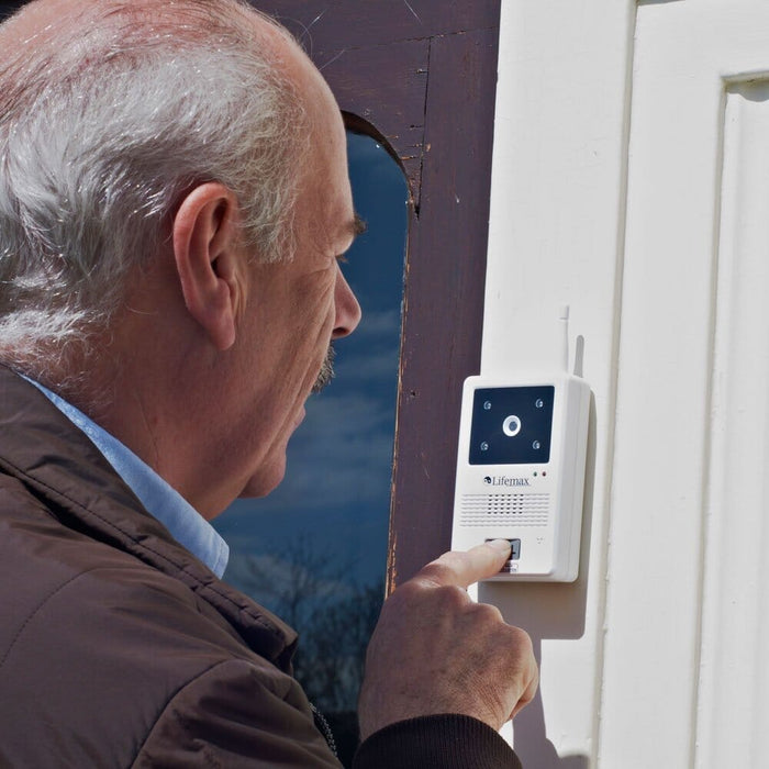 Wireless Video Door Phone being held in a hand, showing the size of the buttons and screen.