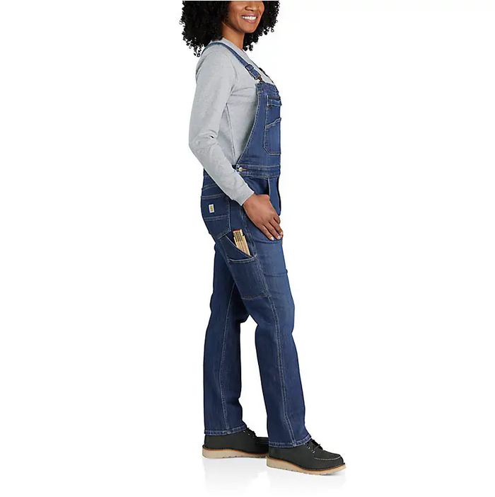 Arches wash Carhartt women's denim bib overall with side leg utility pocket and relaxed fit through the hip