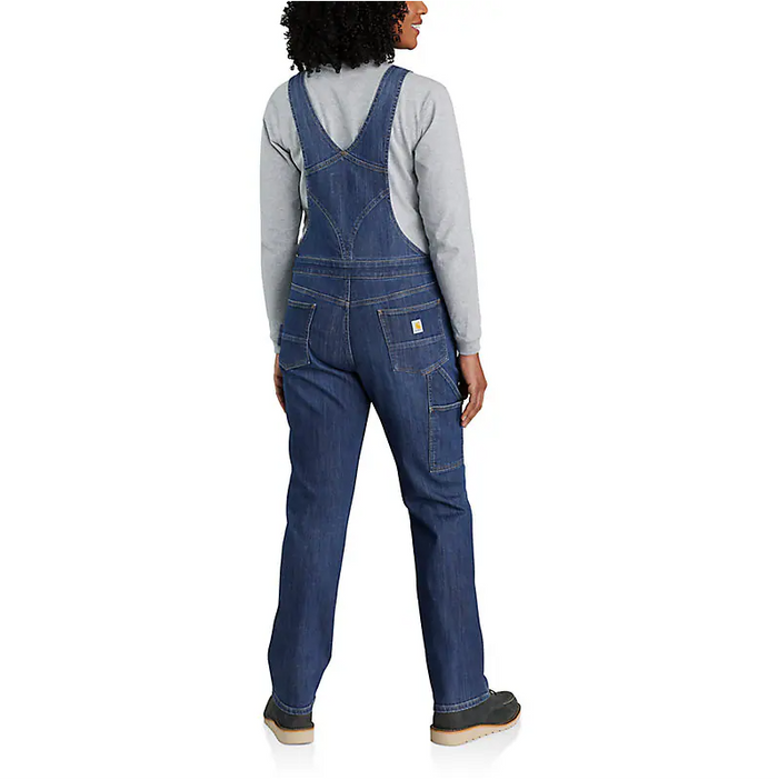 Carhartt women's denim bib overall in Arches wash showing reinforced stitching and metal hardware