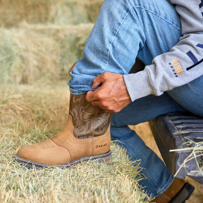 Ariat WorkHog pull-on work boot in aged bark leather, shown worn in a job site setting
